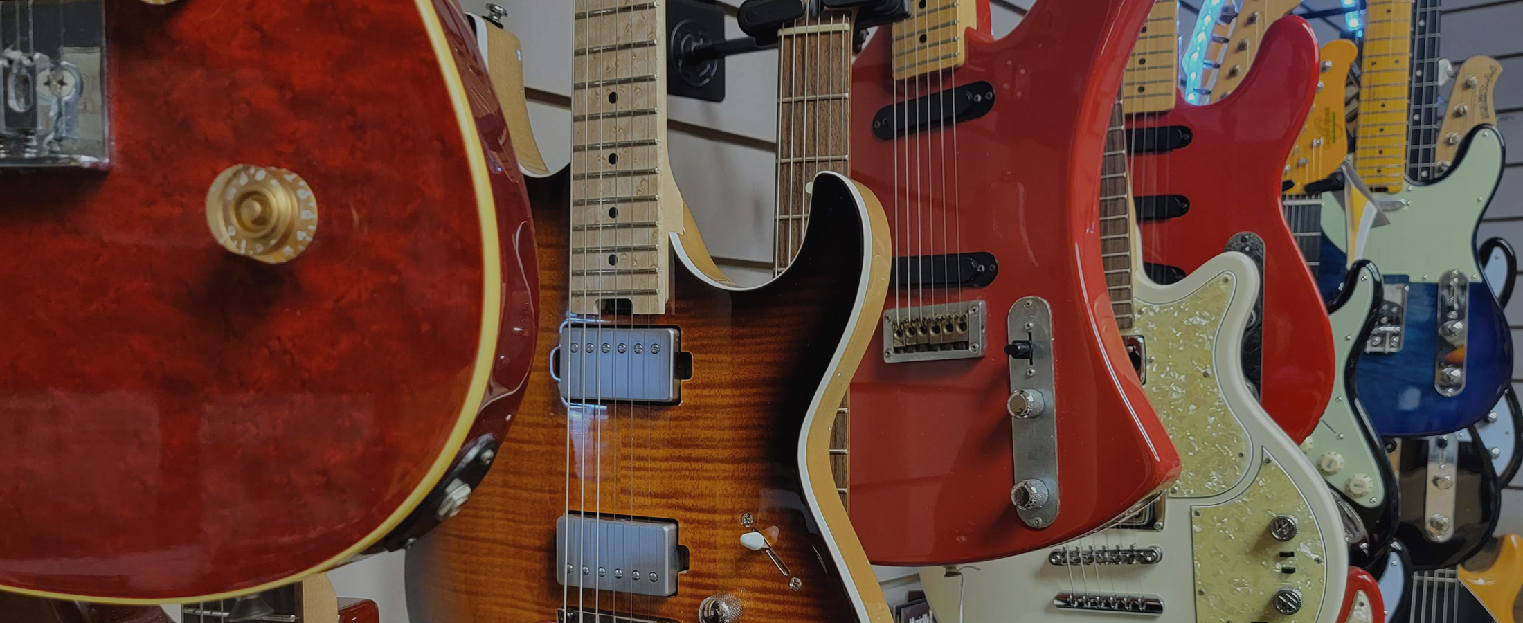 image of nice electric guitars hanging on the wall at Westside Music Hawaii