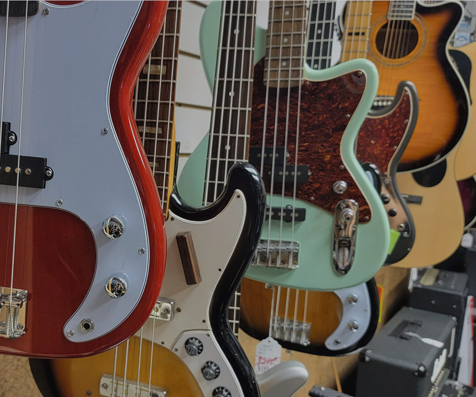 image of man plugging in guitar that he bought at WestSide Music.